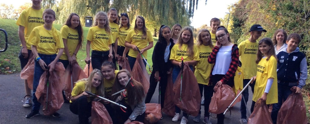 Community Ambassadors pictured in a park on a litter pick
