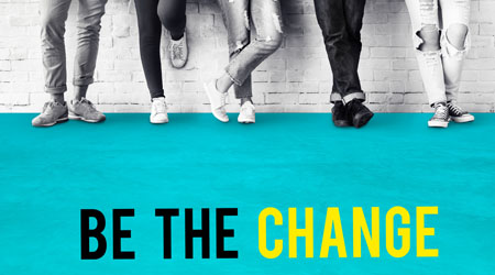 Some people's legs pictured against a wall with the text 'Be the Change' below them.